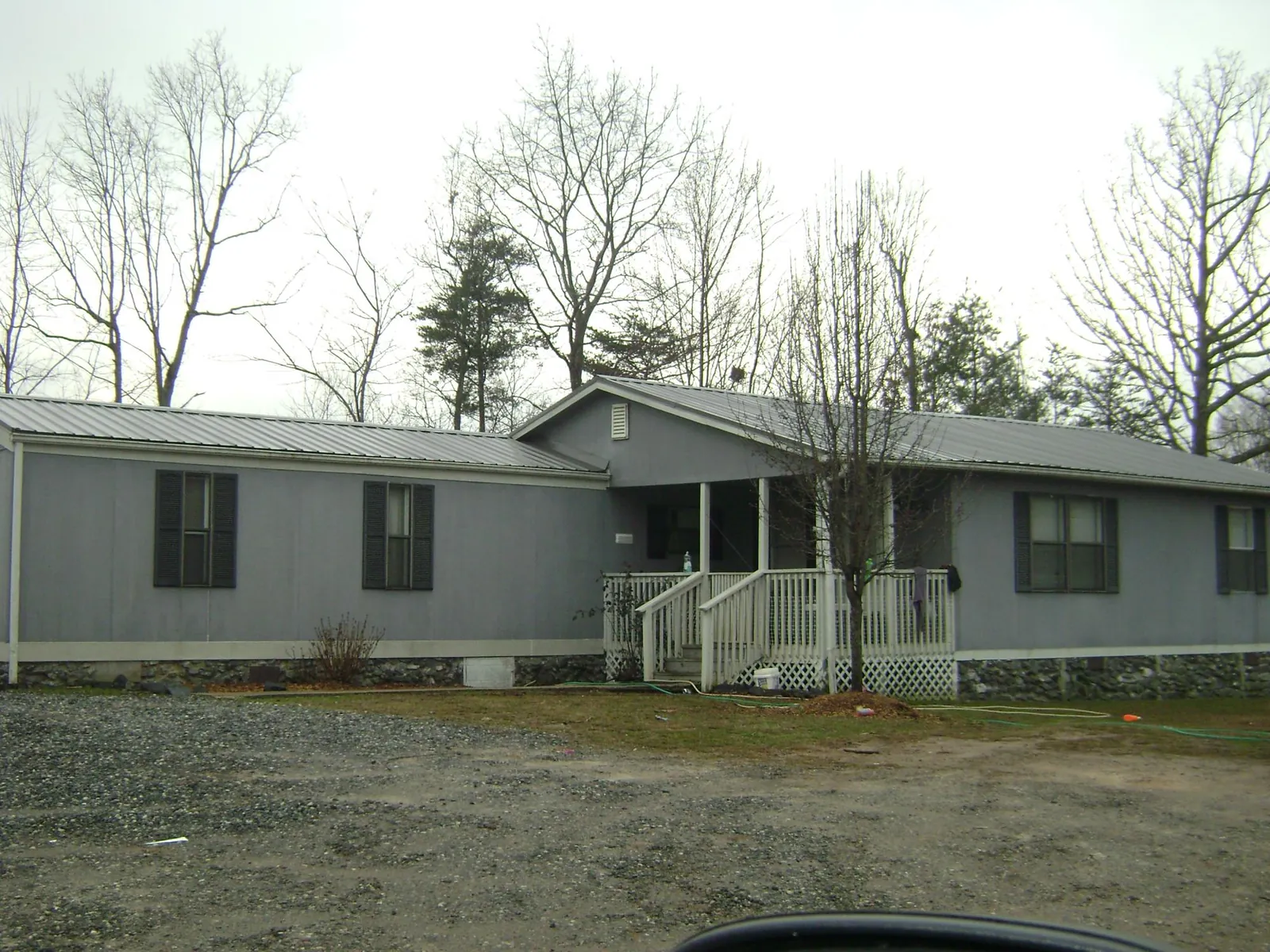 Metal roof over a manufactured home with a covered front porch in Winsted